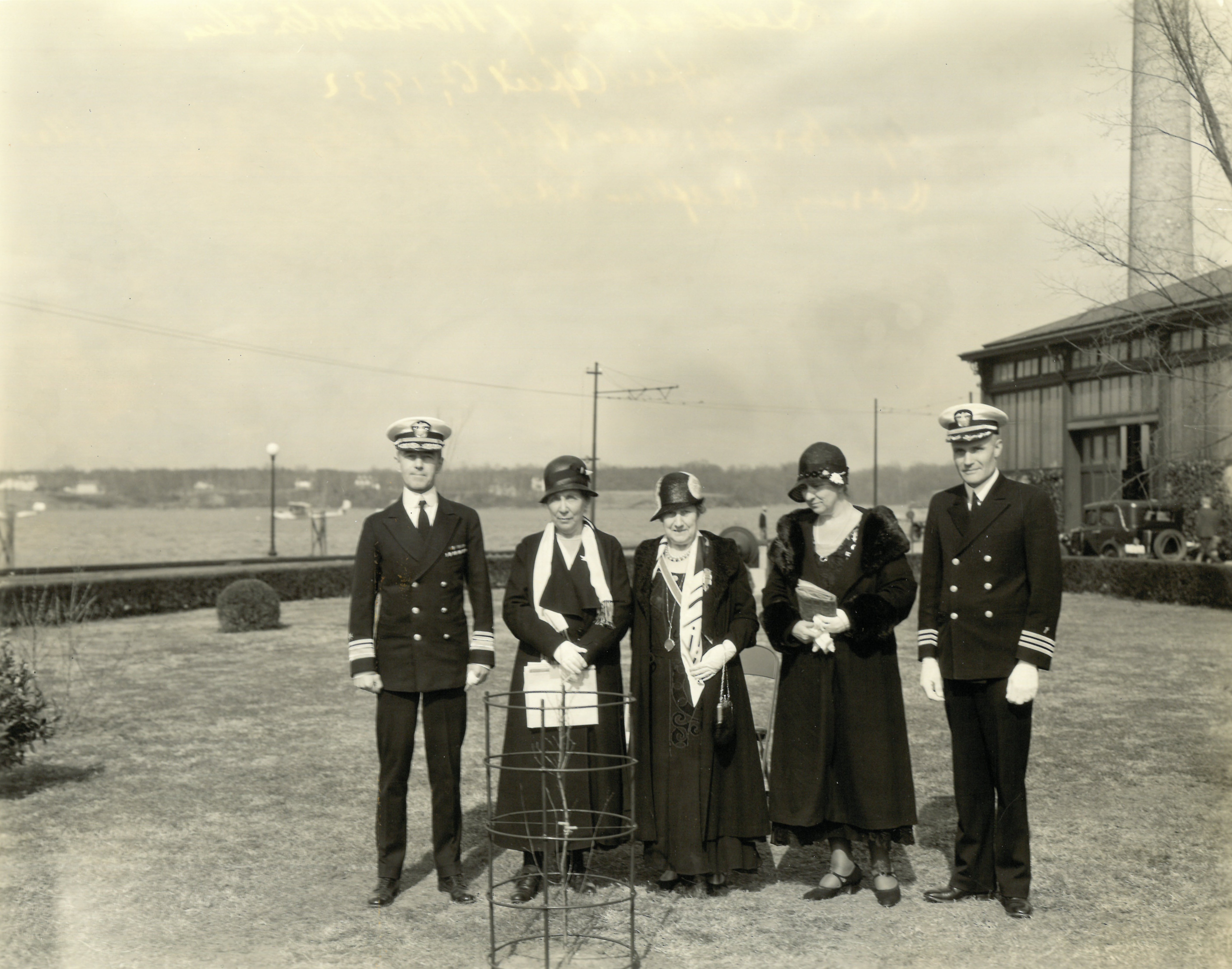 From left to right, standing behind the scion of the Cambridge Washington Elm, Rear Admiral Thomas G. Hart, Superintendent of the Naval Academy; Louisa Taylor Alger, regent of the Peggy Stewart Tea Party Chapter of the DAR; "the Regent DAR," presumably Annie Elizabeth Thomas Lilburn, Maryland state regent; Alice Paret Dorsey, DAR National Vice Chairman, Eastern Division--Conservation and Thrift; Chaplain Frank H. Lash.
