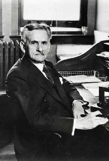 Albert A. Michelson, about 1927, seated at his desk