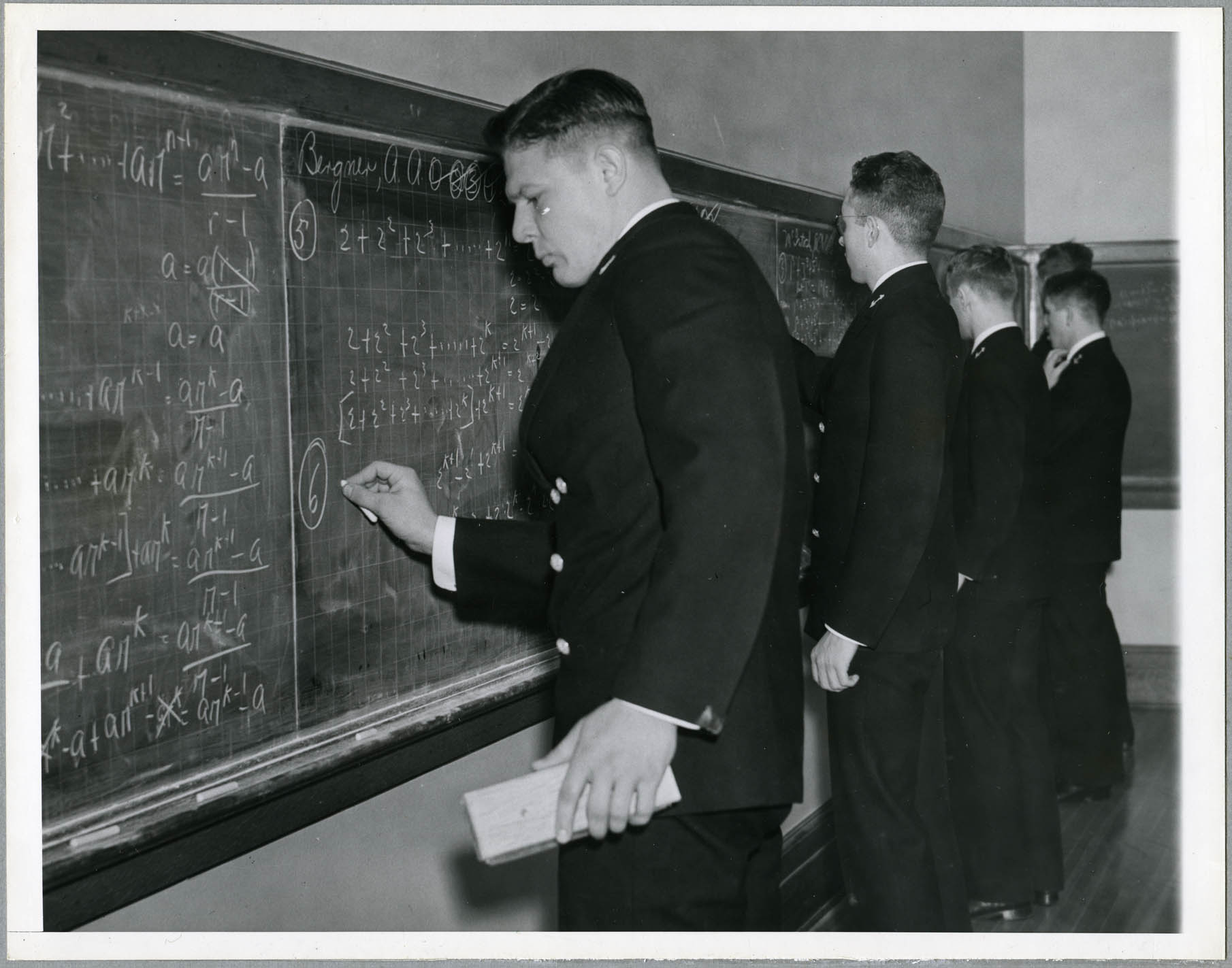 Students verifying formulas for geometric sums by induction, academic year 1936-1937.