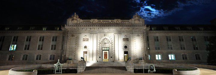 Bancroft Hall at night with clouds